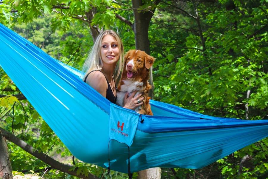 woman with dog in hammock