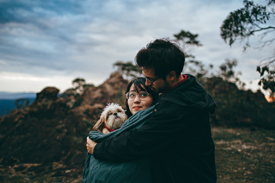 dog owners holding small dog