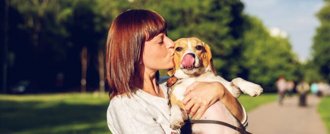 pet owner with holding dog