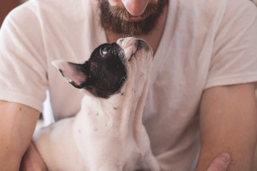 man with a puppy in his arms