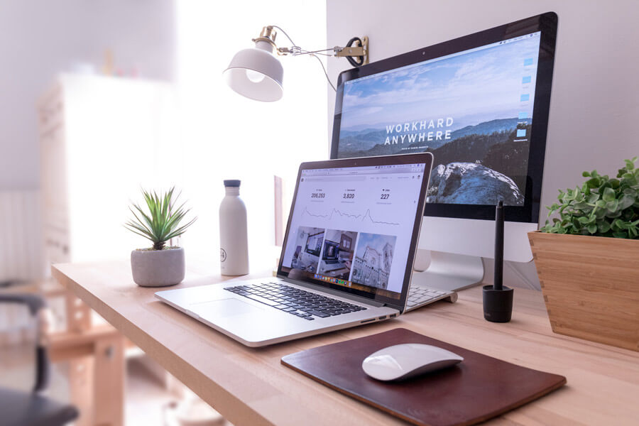 computer and laptop on home office desk