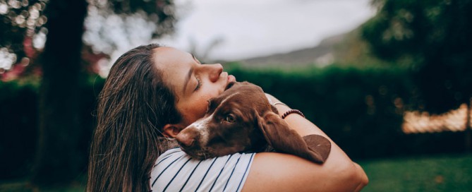 woman hugging dog, dealing with difficult clients