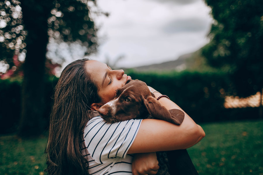 woman hugging dog, dealing with difficult clients