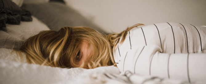 woman lying on bed, veterinary burnout