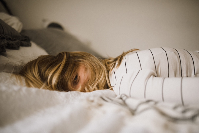 woman lying on bed, veterinary burnout