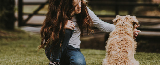 young girl petting dog outdoors, kids and pets